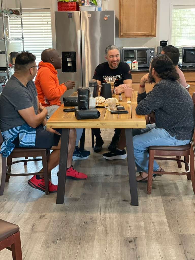 Adam with the community around the table